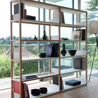 Modern wood shelving unit with light natural wood and white accents, featuring a minimalist design and geometric patterns.