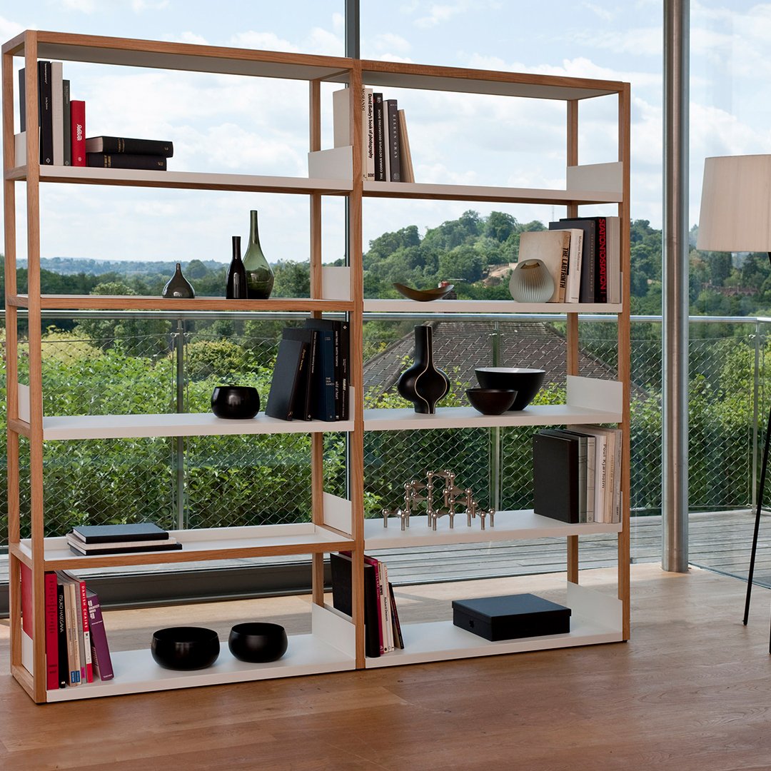 Modern wooden bookshelf featuring natural wood tones and white shelves, showcasing a minimalist design.