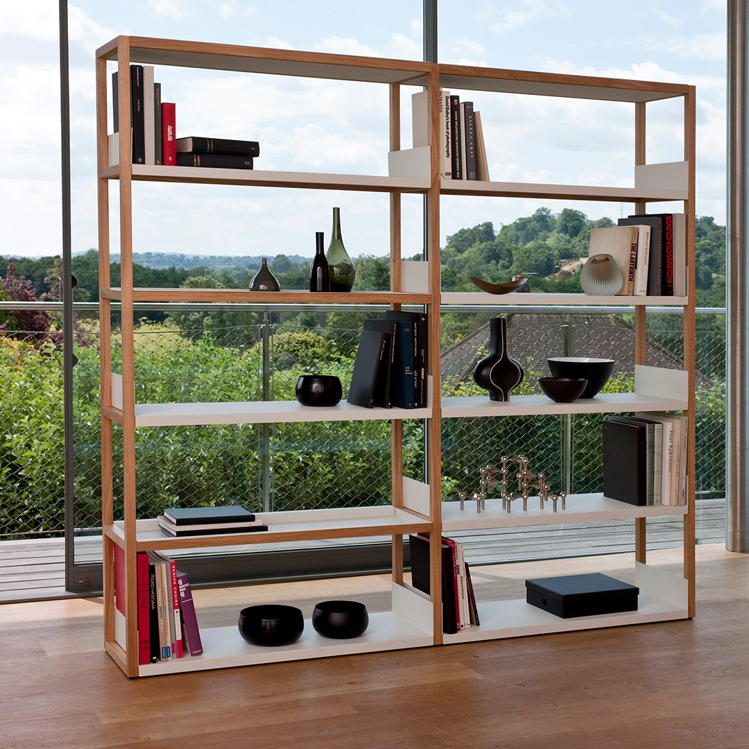 Modern wooden bookshelf with natural oak finish and white shelves, showcasing a minimalist design and stylish decor.