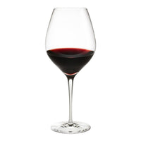 Elegant clear wine glass filled with rich, deep red wine, showcasing smooth curves and a classic design.