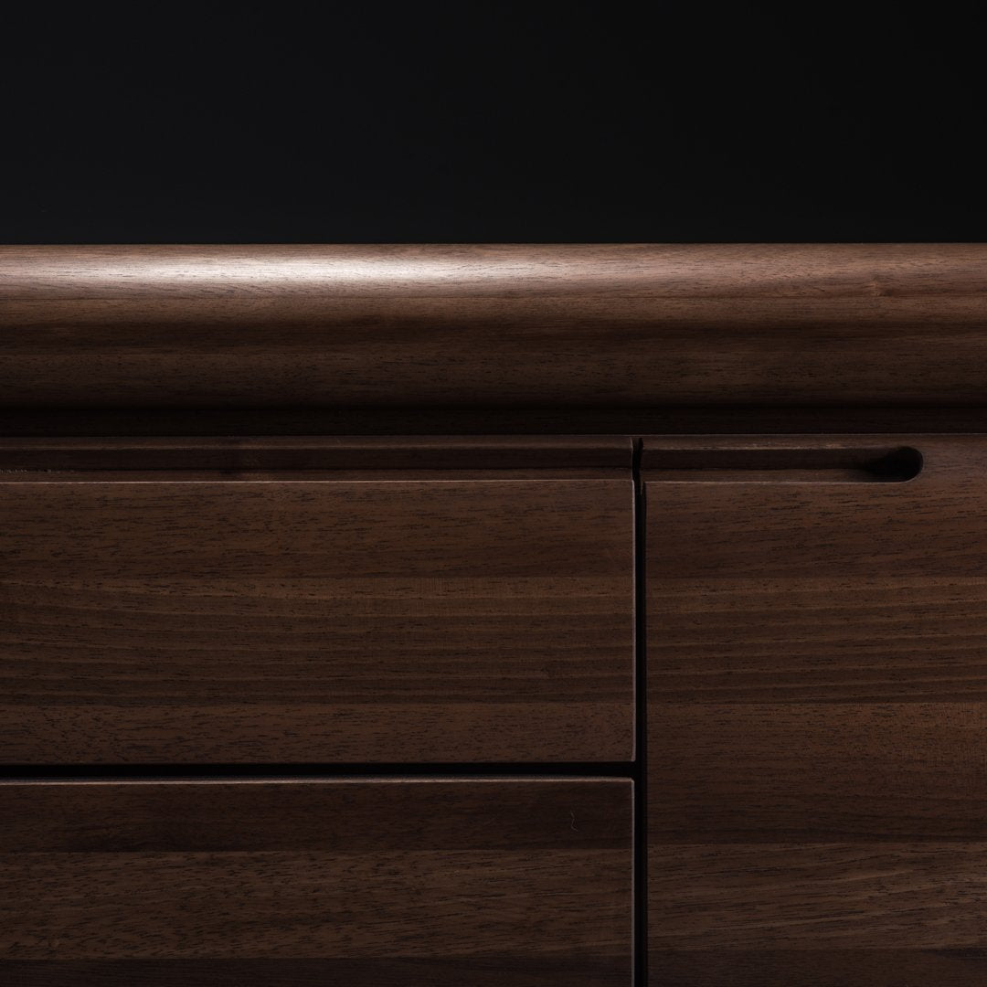 Dark wooden surface featuring smooth, glossy finish with subtle grain patterns on a black background.