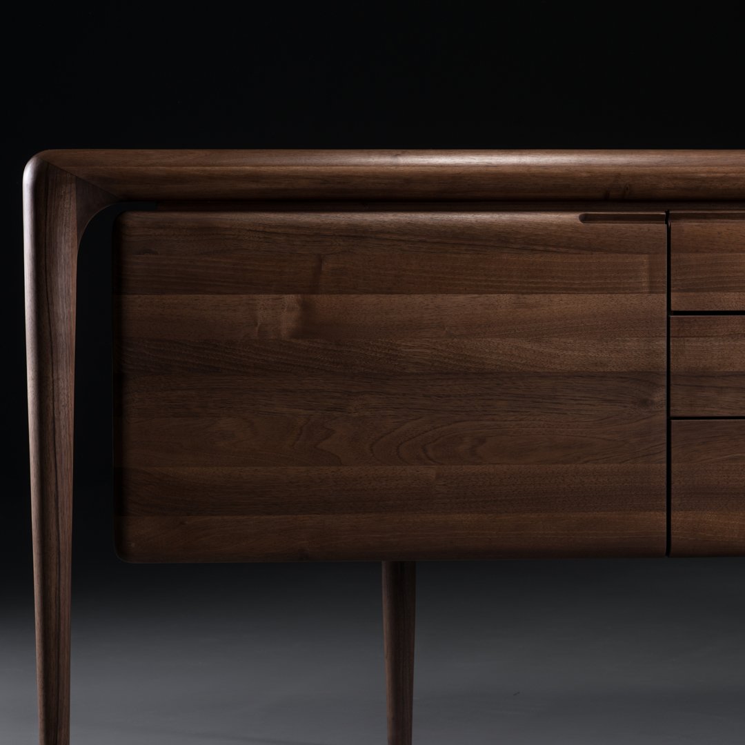 Dark walnut wood sideboard with sleek lines and smooth finish, featuring a minimalist design perfect for modern interiors.