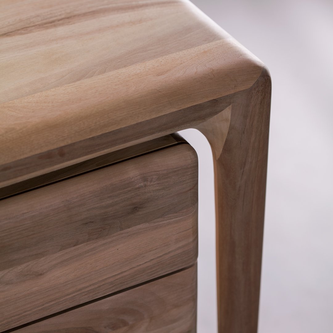 Light brown wooden furniture with smooth, natural finish and soft curves, highlighting warm wood tones and textures.