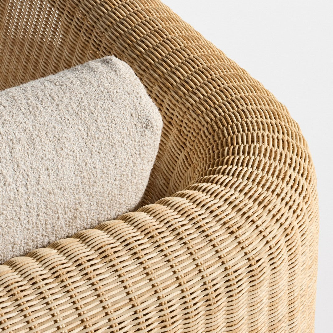 Natural woven rattan in golden beige with a textured cream cushion for a cozy, modern look.