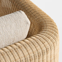 Natural woven rattan in golden beige with a textured cream cushion for a cozy, modern look.