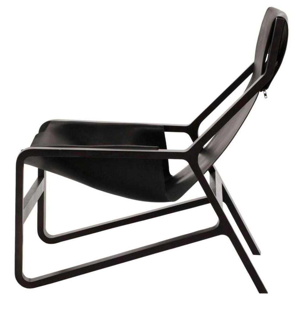 "Modern black lounge chair with sleek, minimalistic design and smooth contours."