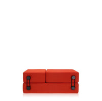 Bright red sofa with a minimalist design and contrasting black accents. Perfect for modern decor.