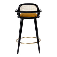 Black bar stool with a woven back, mustard seat, and gold footrest, featuring a modern and stylish design.