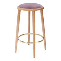 Lavender cushioned stool with natural wooden legs and a metallic gold footrest, featuring a sleek, modern design.