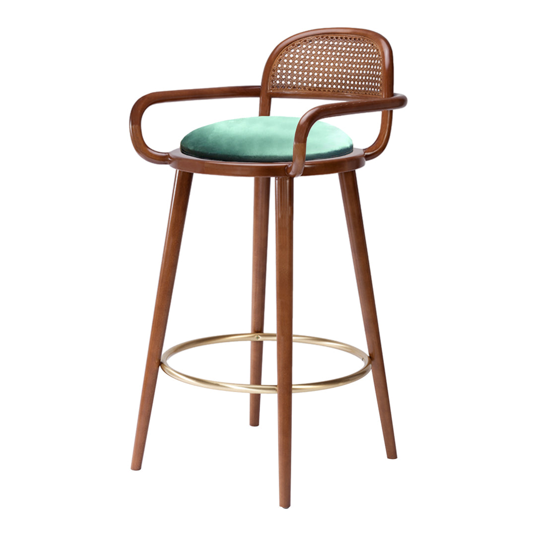 Wooden bar stool with a cane back, mint green cushion, and gold footrest. Modern design with natural tones.