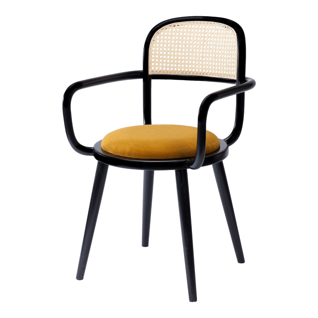 Stylish black chair with a vibrant yellow cushion and a woven cane backrest, perfect for modern decor.