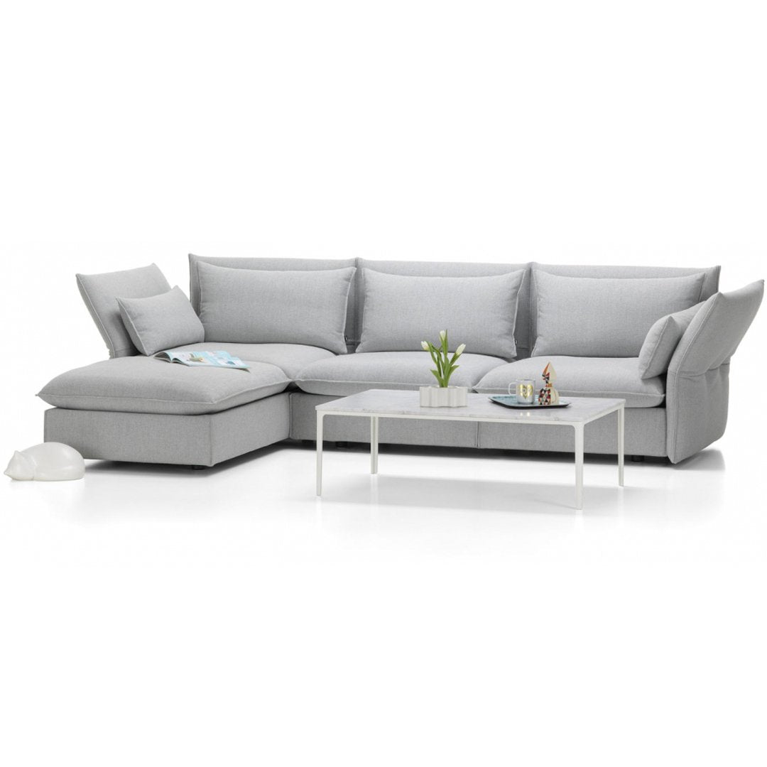 Modern gray sectional sofa with soft fabric upholstery and a sleek, minimalistic design. Perfect for stylish living spaces.