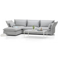 Modern gray sectional sofa with soft fabric upholstery and a sleek, minimalistic design. Perfect for stylish living spaces.