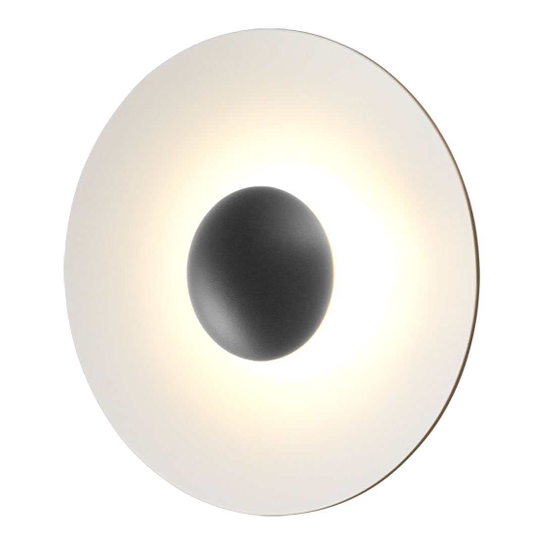 Minimalist wall lamp with a circular white shade and a central black accent, offering a modern aesthetic.