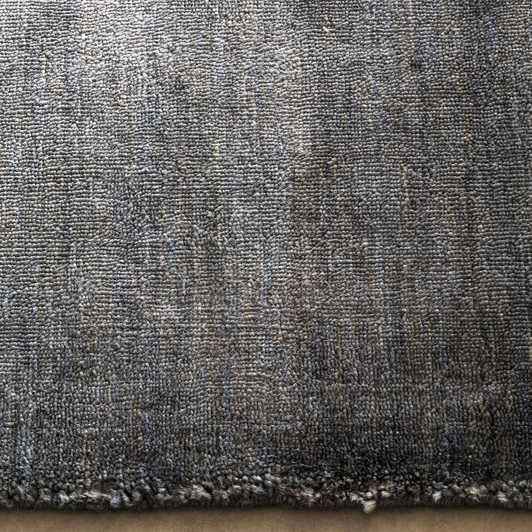 Textured fabric featuring a mix of gray and blue tones with subtle striations. Perfect for modern home decor.