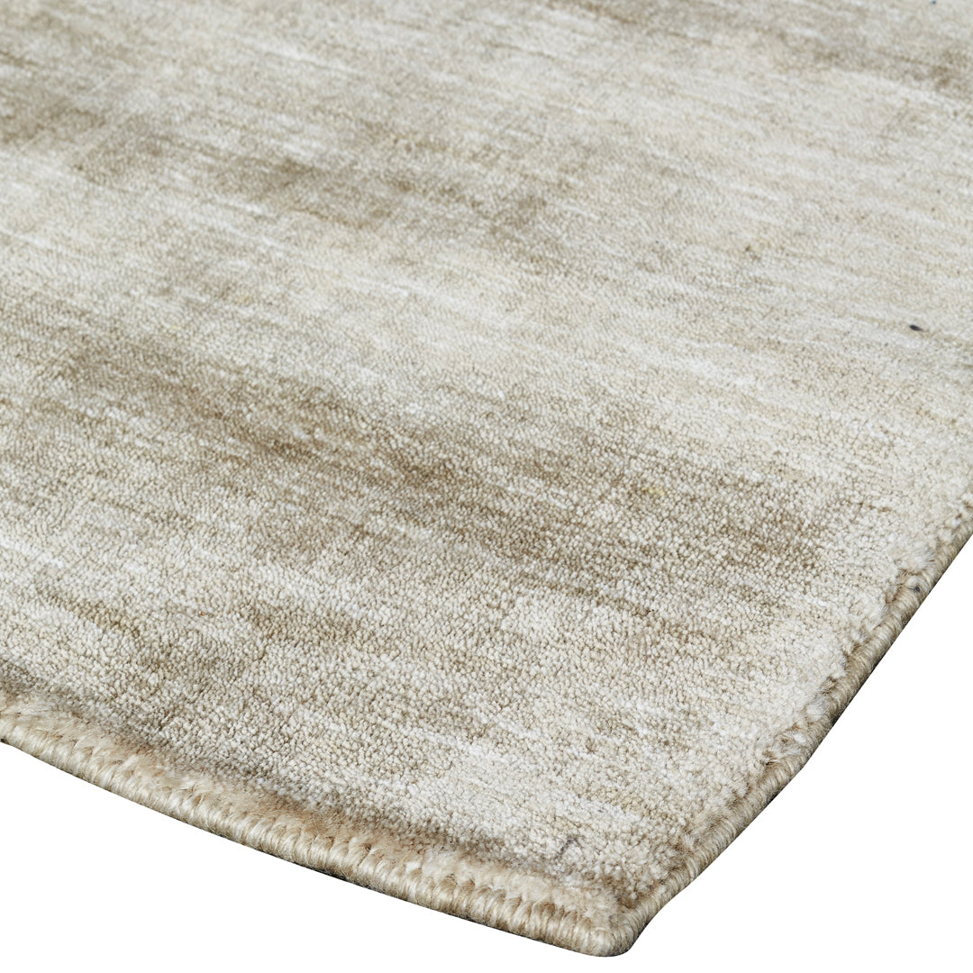 Beige textured rug with subtle variations and a soft, muted pattern for a cozy, neutral aesthetic.