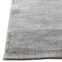 Soft gray area rug with a subtle textured pattern, perfect for modern decor. Ideal for adding elegance to any space.