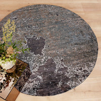 Round rug featuring a textured blend of gray, blue, and subtle patterns for a modern, stylish look.