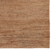 Natural brown textured area rug with subtle variations in tone and a woven pattern, perfect for enhancing any room.