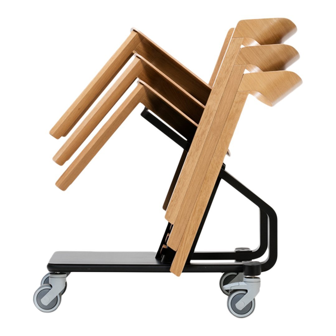 Stacked wooden chairs with a light wood finish, featuring a sleek black metal base and smooth caster wheels.