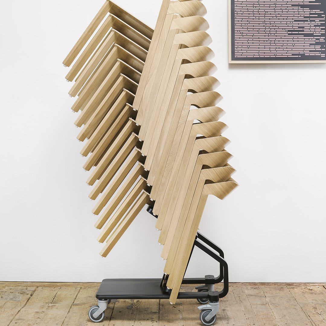 Stacked wooden chairs on a wheeled black base, showcasing a natural wood finish and sleek, minimalist design.