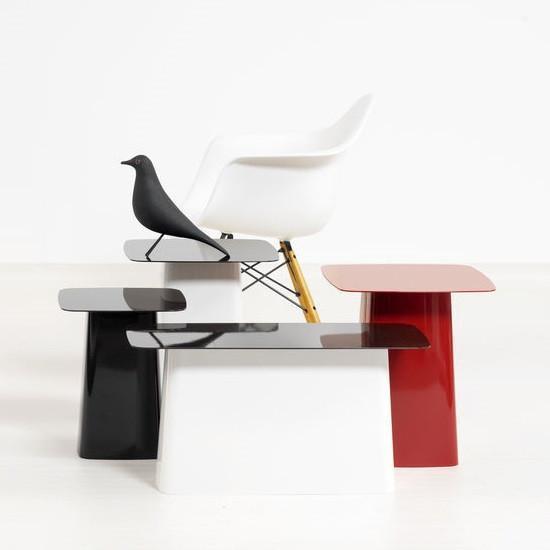 Set of modern side tables in glossy black, white, and red finishes with smooth, minimalist designs.