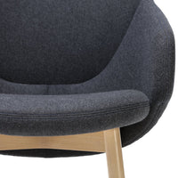 Cozy dark gray upholstered chair with a smooth, rounded design and light wood legs, perfect for modern interiors.