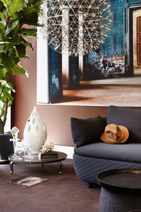 Elegant blue and earthy tones with geometric patterns in a modern living space featuring a chic vase and stylish decor.