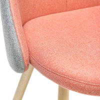 Coral and gray patterned chair upholstery with sleek wooden legs, perfect for modern decor.
