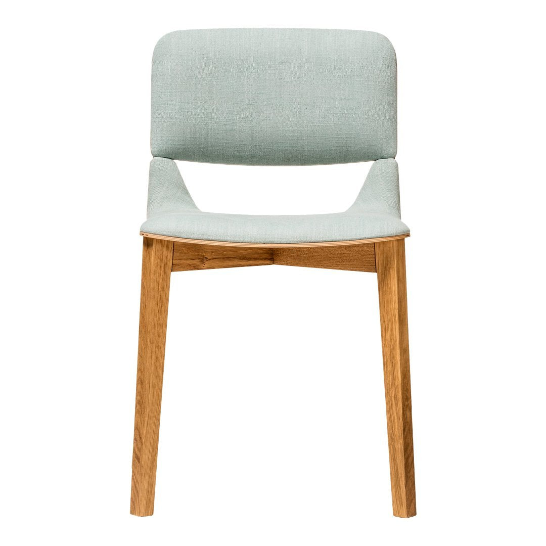 Light blue upholstered chair with natural wood legs, featuring a minimalist design and subtle texture.