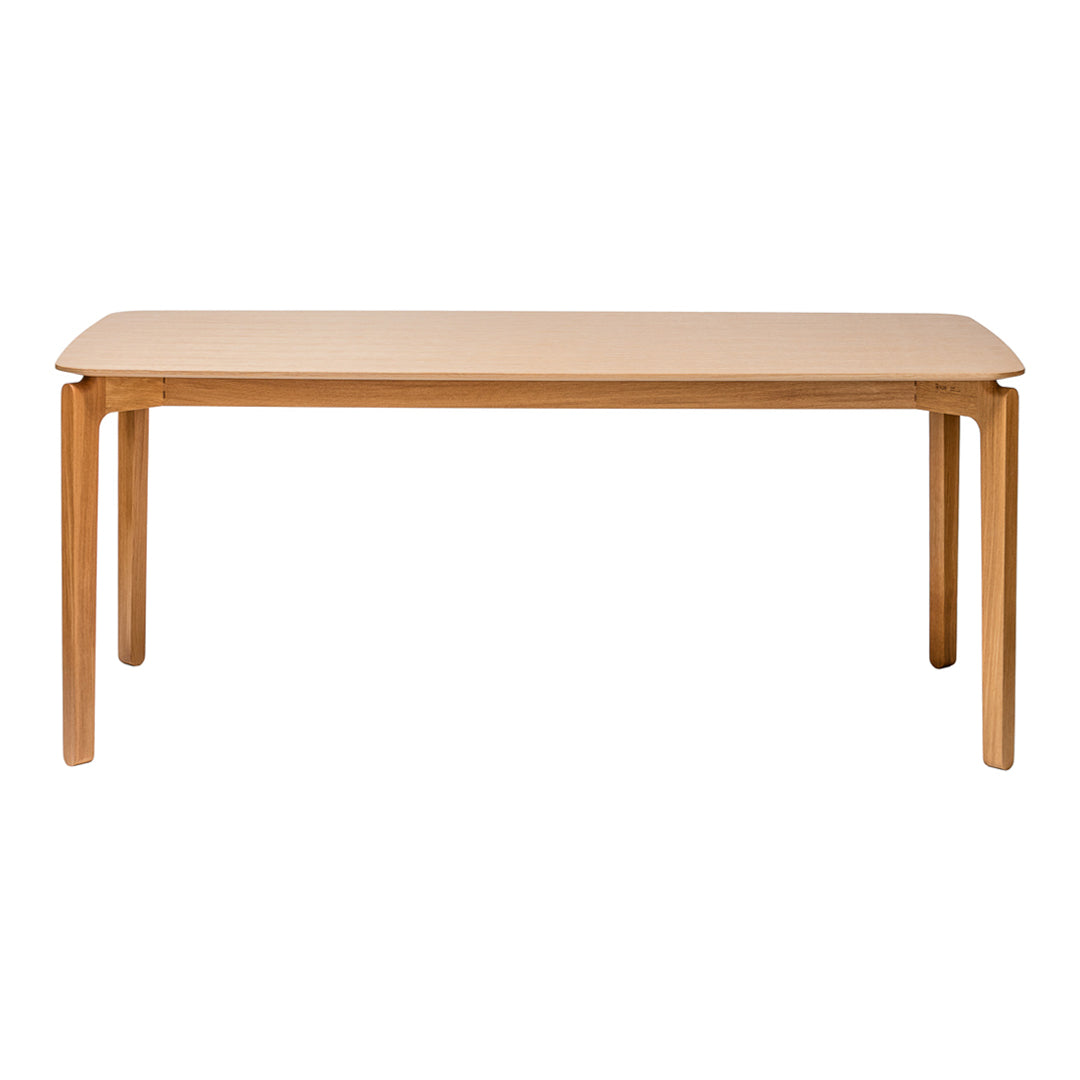 Natural wood dining table with smooth, light beige surface and simple, clean lines. Perfect for modern interiors.