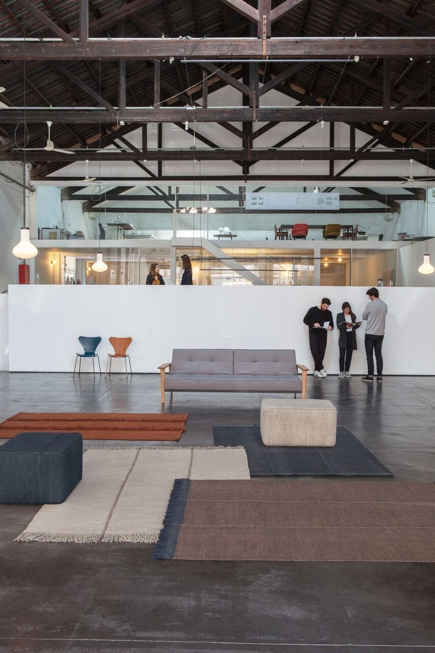 "Modern rugs featuring geometric patterns in neutral tones, blues, and browns, enhancing contemporary interior decor."