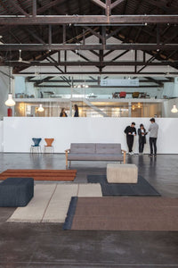 "Modern rugs featuring geometric patterns in neutral tones, blues, and browns, enhancing contemporary interior decor."