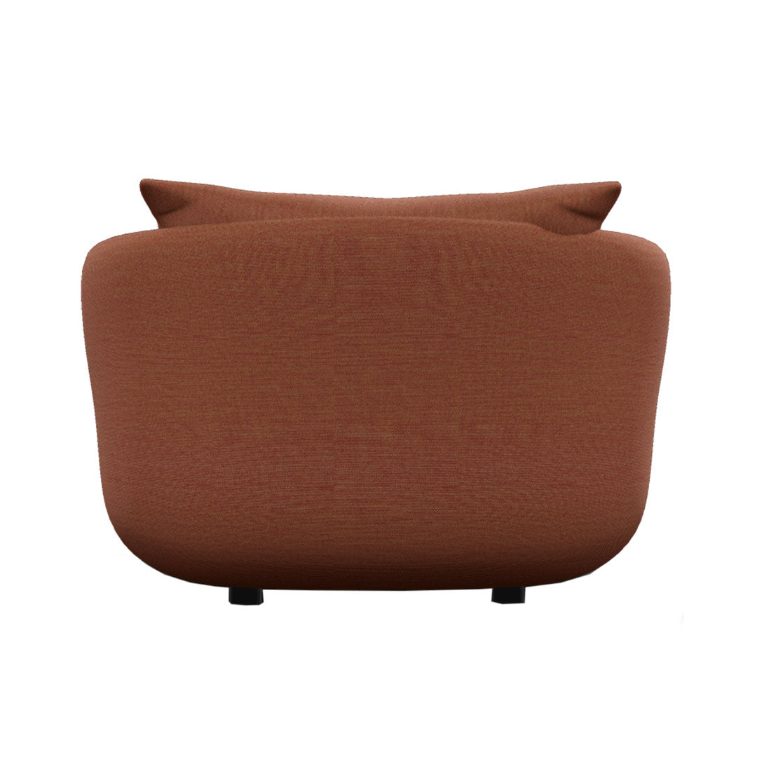 Rust-colored sofa with a smooth texture and minimalist design, featuring subtle curved lines.