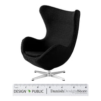 Black upholstered modern chair with a sleek, minimalist design and a polished silver base. Perfect for stylish interiors.