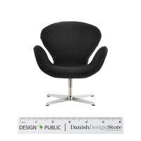 Black textured swivel chair with a sleek metal base, featuring a modern minimalist design. Perfect for stylish interiors.