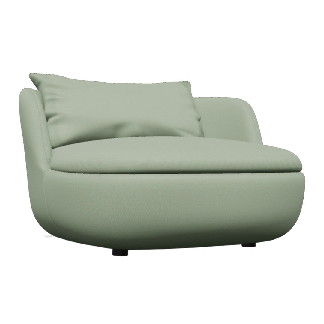 Soft green curved armchair with a smooth, solid fabric and a plush back cushion. Ideal for modern interiors.