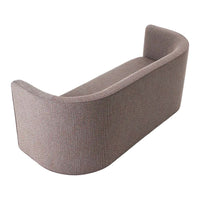 Curved sofa in soft gray fabric with a subtle textured pattern, ideal for modern interiors.