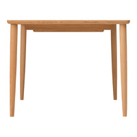 Natural wood dining table with a light oak finish and sleek, minimalist design. Simple, modern aesthetic.