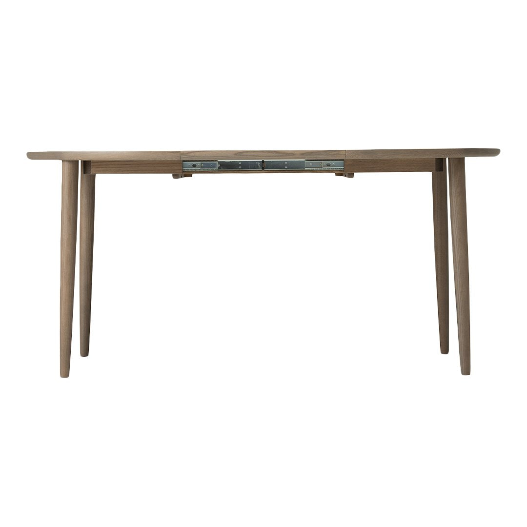 Light wood dining table with simple, modern design and natural finish, featuring a subtle grain pattern.