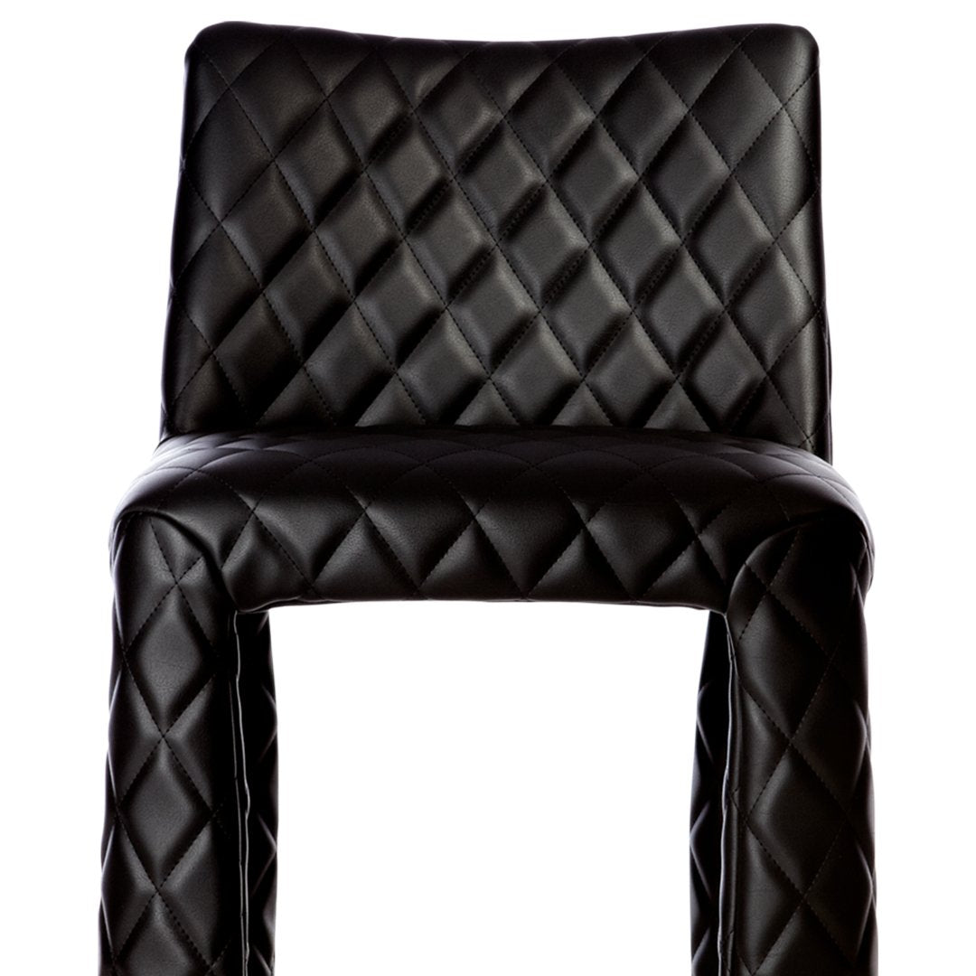 Black quilted bar stool featuring a textured diamond pattern for a modern, stylish look.