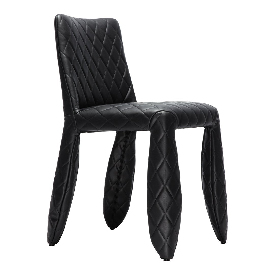 Black quilted dining chair with a diamond pattern and unique leg design, perfect for modern decor.