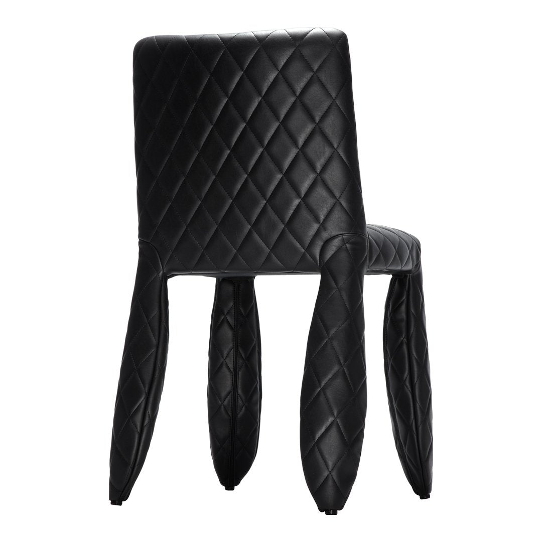 Black quilted chair with unique curved legs, featuring a diamond pattern and sleek, modern design.