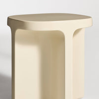Beige modern stool with a smooth, minimalist design and rounded edges, perfect for contemporary decor.