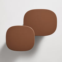 Two smooth, rounded decorative trays in warm brown tones, showcasing a minimalist design and modern aesthetic.