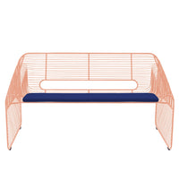 Coral wireframe bench with a solid navy cushion; modern design with clean lines and contrasting colors.