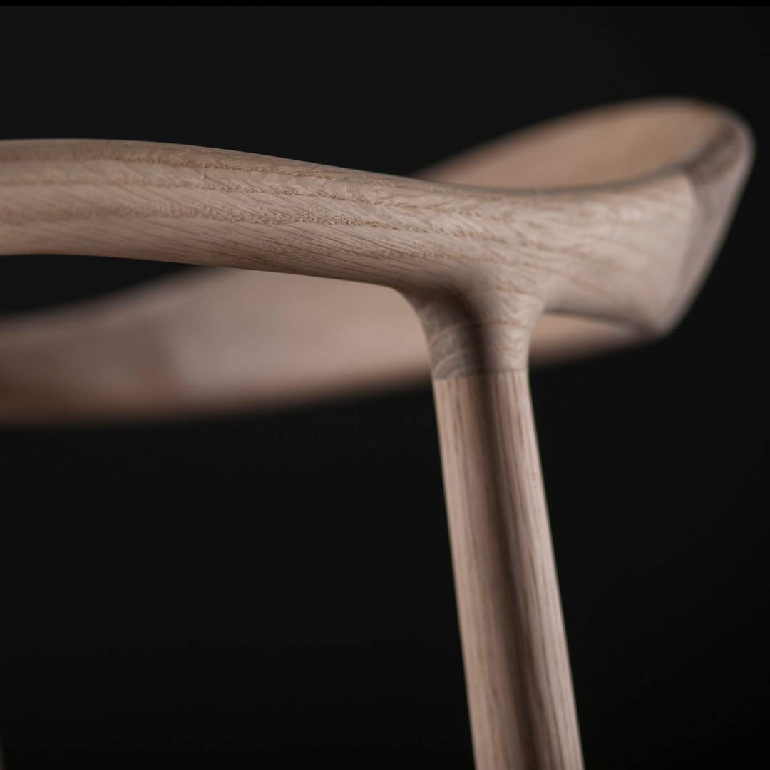 Natural wood grain with smooth, light brown tones against a dark background, highlighting minimalist design.