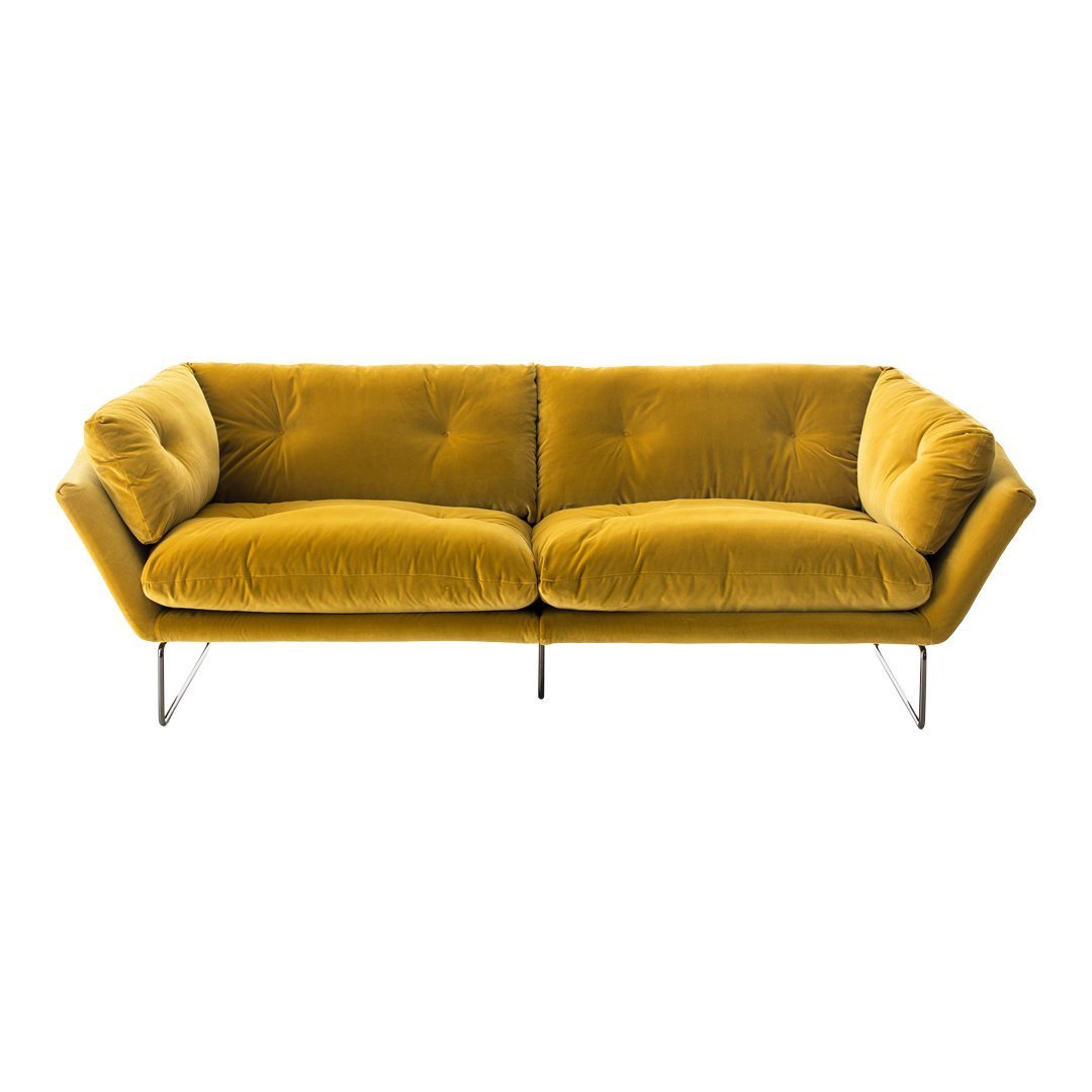 Velvet mustard yellow sofa with tufted design and sleek metal legs, perfect for modern decor.