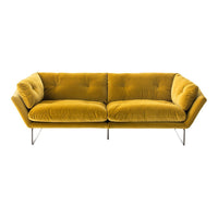Velvet mustard yellow sofa with tufted design and sleek metal legs, perfect for modern decor.