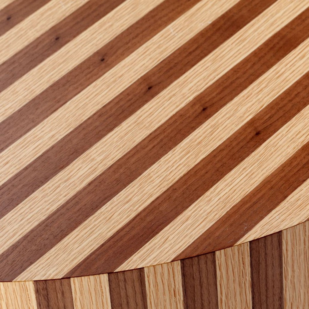 Close-up of a wooden surface featuring diagonal stripes in rich brown and light beige tones.